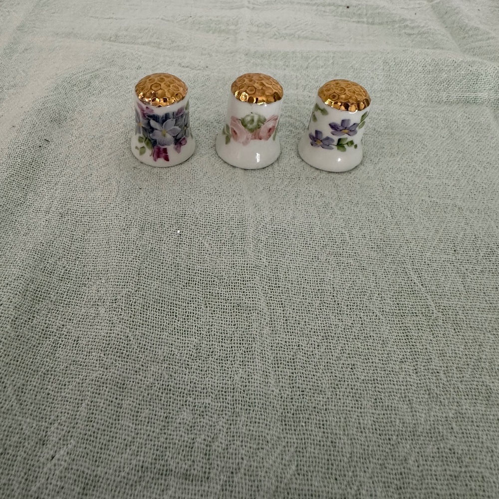3 Hand painted porcelain thimbles.